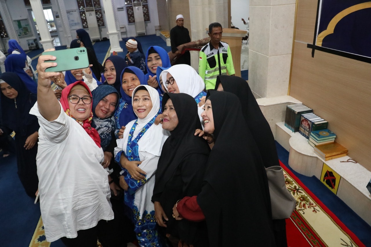 WAGUB Marlin, melayani ajakan jemaah foto bersama di sela menghadiri kegiatan rutin bulanan BKMT Batamkota, berupa pengajian di Masjid Jamik Al Ikhlas, Seipanas, Jumat (20/1/2023).